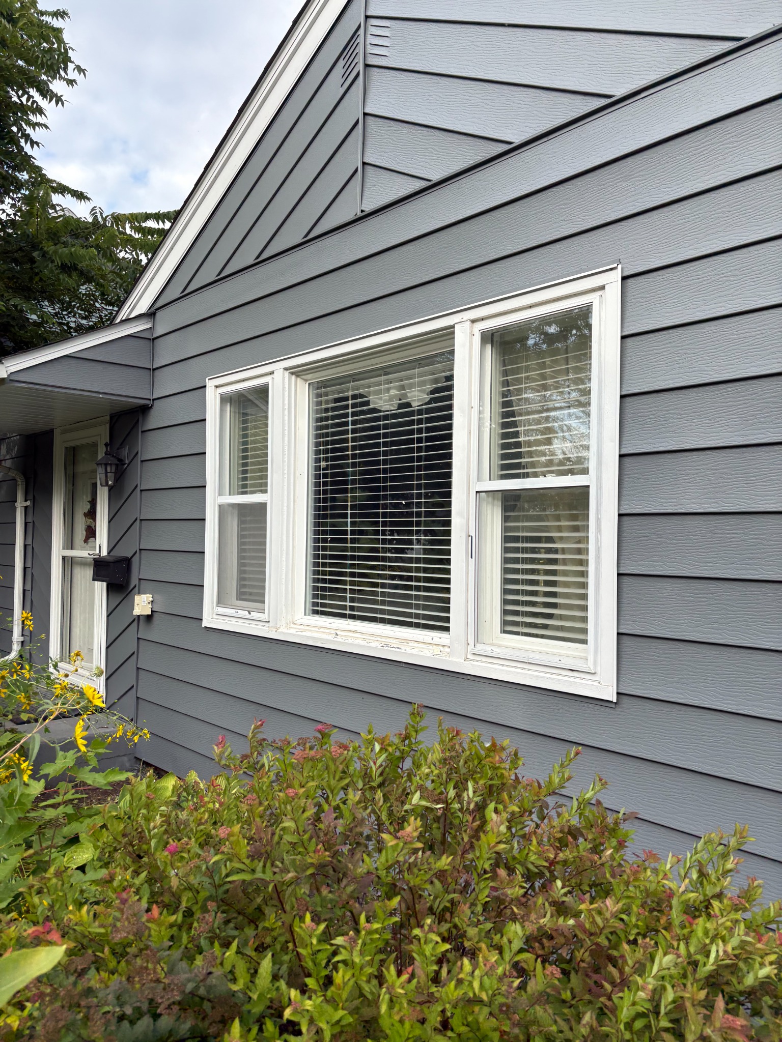 Completed gray exterior siding paint project